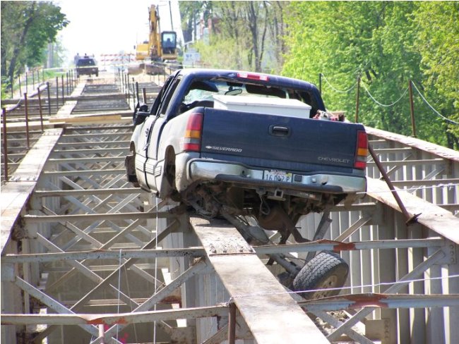 Wrecked Truck Teetering on Bridge
